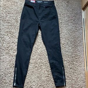 Black jeans with zippers on the ankles